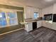 Bright kitchen with white cabinets, gray flooring, and a breakfast bar at 5737 Lorraine Dr, Stone Mountain, GA 30087