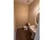 Cozy half bathroom featuring a pedestal sink and wood-look flooring at 125 Odyssey Turn, Conyers, GA 30012