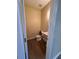 Cozy half bathroom featuring a pedestal sink and wood-look flooring at 125 Odyssey Turn, Conyers, GA 30012