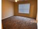 A cozy bedroom featuring neutral walls, carpet, and a window with bright, natural light at 125 Odyssey Turn, Conyers, GA 30012