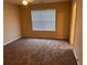 A spacious bedroom featuring neutral walls, carpet, and a bright window for natural light at 125 Odyssey Turn, Conyers, GA 30012