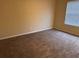 This bedroom features neutral walls, carpet, and a window allowing for bright, natural light at 125 Odyssey Turn, Conyers, GA 30012