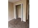 Bedroom with bi-fold closet door, neutral paint, and carpet at 125 Odyssey Turn, Conyers, GA 30012