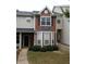 Charming brick townhouse with manicured bushes and inviting entrance at 125 Odyssey Turn, Conyers, GA 30012
