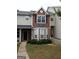 Brick front exterior of townhome with landscaping and walkway at 125 Odyssey Turn, Conyers, GA 30012