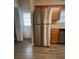 Updated kitchen features a stainless steel refrigerator, dishwasher, and wood cabinets at 125 Odyssey Turn, Conyers, GA 30012