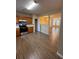 Open kitchen boasts modern appliances, wood cabinets, tile backsplash, and wood-look flooring at 125 Odyssey Turn, Conyers, GA 30012