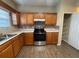 Well-appointed kitchen features stainless steel appliances, tile backsplash, and wood-look flooring at 125 Odyssey Turn, Conyers, GA 30012