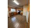 Spacious kitchen featuring wood cabinets, stainless steel appliances, and wood-look flooring at 125 Odyssey Turn, Conyers, GA 30012