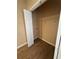 Bright pantry with wood-look flooring and white door and wire shelving at 125 Odyssey Turn, Conyers, GA 30012