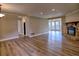 Open concept living room featuring a fireplace, wood-look floors, and lots of light at 3412 Lake Pointe Cir, Roswell, GA 30075