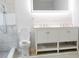 Modern bathroom with a double sink vanity, an illuminated mirror, and a sleek shower with marble accents at 1421 Eason St, Atlanta, GA 30314