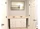 Bathroom featuring a dual vanity with white cabinetry, a well-lit mirror, and modern fixtures at 1421 Eason St, Atlanta, GA 30314