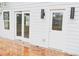 View of the back exterior featuring access to the house from a deck with a door and glass sliding doors at 1421 Eason St, Atlanta, GA 30314