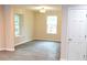 Bright living room featuring new gray flooring, neutral walls, and lots of natural light at 1421 Eason St, Atlanta, GA 30314