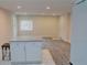 Bright living room with fresh paint, light-colored flooring, modern lighting, and a kitchen island with a granite countertop at 1421 Eason St, Atlanta, GA 30314