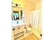 Bright bathroom with a single sink vanity, floral-patterned floors, and clean, modern fixtures at 94 Moury Se Ave, Atlanta, GA 30315