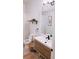 Cozy bathroom featuring modern fixtures, wood accents, a decorative mirror, and a patterned shower curtain at 94 Moury Se Ave, Atlanta, GA 30315