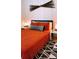 Charming bedroom featuring a comfortable bed with stylish orange bedding and a decorative pattern rug at 94 Moury Se Ave, Atlanta, GA 30315