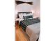Cozy bedroom with a wood frame bed with decorative black and white patterned throw pillows at 94 Moury Se Ave, Atlanta, GA 30315