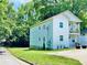 Charming two-story home with a well maintained lawn and mature trees enhancing its curb appeal at 94 Moury Se Ave, Atlanta, GA 30315