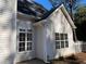 White vinyl sided house with gray roof and large windows at 1835 Freeman Road, Jonesboro, GA 30236