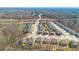 An aerial view shows modern homes in a suburban neighborhood nestled near a tranquil lake and lush woods at 2536 Dayview Ln, Atlanta, GA 30331