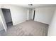 Bedroom with an open closet featuring plush gray carpet, neutral walls, and natural light at 2536 Dayview Ln, Atlanta, GA 30331