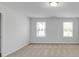 Bright bedroom featuring neutral carpet, ample natural light from two windows and modern ceiling light at 2536 Dayview Ln, Atlanta, GA 30331