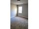 Bedroom featuring plush gray carpet, neutral walls, and a bright window with blinds at 2536 Dayview Ln, Atlanta, GA 30331