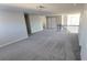 Bright bonus room featuring neutral walls, plush gray carpet, staircase with white railing, and natural light at 2536 Dayview Ln, Atlanta, GA 30331