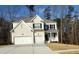 Charming two-story home with a painted brick exterior, black shutters and a two car garage at 2536 Dayview Ln, Atlanta, GA 30331