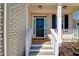 Inviting front porch of a brick home with a classic black door and white railing, creating a warm entrance at 2536 Dayview Ln, Atlanta, GA 30331