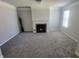 Cozy living room with a charming fireplace, neutral walls, plush gray carpet, and bright window at 2536 Dayview Ln, Atlanta, GA 30331