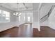 Open-concept living space with hardwood floors, coffered ceilings, a chandelier, and a staircase to the second floor at 2536 Dayview Ln, Atlanta, GA 30331