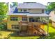 Expansive backyard featuring a deck, enclosed porch, and wooden staircase to the ground at 2548 Brentmoor Ct, Suwanee, GA 30024