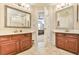 Bright bathroom with double sinks, a mirror over each vanity, and tile flooring that leads to the bedroom at 2548 Brentmoor Ct, Suwanee, GA 30024