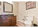 Stylish half bathroom with dark wood vanity and modern fixtures, offering convenience and elegance at 2548 Brentmoor Ct, Suwanee, GA 30024