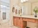 Bright bathroom with a sliding glass shower door and a wood vanity with a neutral countertop and a large mirror at 2548 Brentmoor Ct, Suwanee, GA 30024