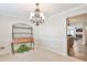 Cozy dining area with elegant chandelier and a view into the adjacent living space at 2548 Brentmoor Ct, Suwanee, GA 30024