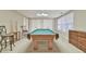 Basement pool room with a billiards table and bar stools in a naturally lit room with two closets at 2548 Brentmoor Ct, Suwanee, GA 30024