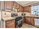 Close-up of a kitchen featuring wood cabinets, tile backsplash, and modern appliances at 2548 Brentmoor Ct, Suwanee, GA 30024