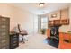 This home office has built in shelves and cabinets, a work space, and a comfortable chair at 2548 Brentmoor Ct, Suwanee, GA 30024