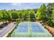 Aerial view of well maintained community tennis courts, with surrounding trees at 2548 Brentmoor Ct, Suwanee, GA 30024