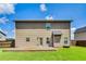 Rear exterior of home with a wooden deck, level yard, and neutral siding at 8051 Nolan Trl, Snellville, GA 30039