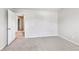 A neutral carpeted bedroom features a doorway and a light-colored neutral paint at 8051 Nolan Trl, Snellville, GA 30039