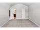 A neutral carpeted bedroom features a doorway and a light-colored neutral paint at 8051 Nolan Trl, Snellville, GA 30039