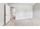 A carpeted bedroom features a doorway and a light-colored neutral paint at 8051 Nolan Trl, Snellville, GA 30039