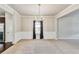 Open dining room features chair rail molding, a chandelier, neutral walls, and a large window at 8051 Nolan Trl, Snellville, GA 30039