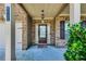 Covered front porch featuring a dark wood front door with sidelights and house numbers at 8051 Nolan Trl, Snellville, GA 30039